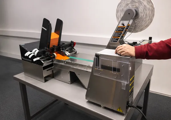 Automated label applicator machine in the bindery