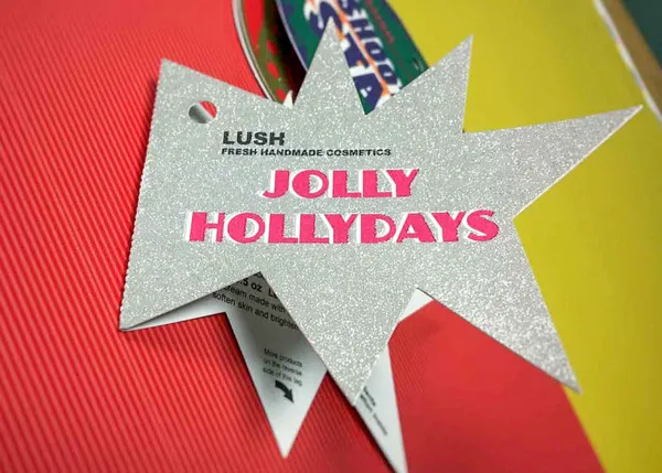 Lush cosmetics tag with silver glitter UV coating