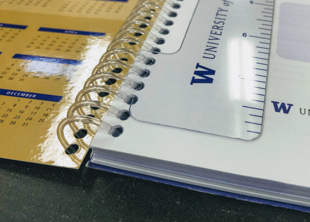 Coil-bound calendar and document with plastic spiral binding